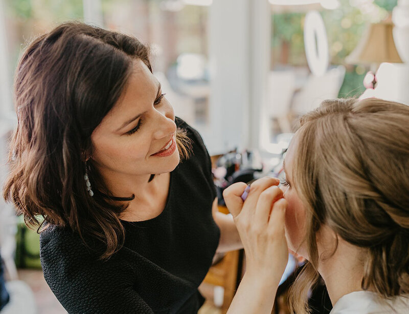 Karyn Carlson applying eyelashes to  a client