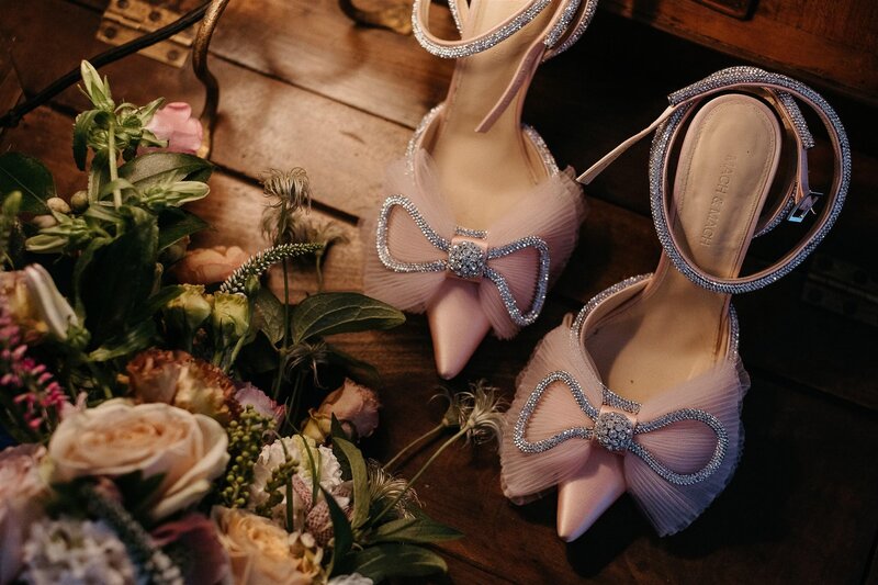 Close up of shoes and flowers.