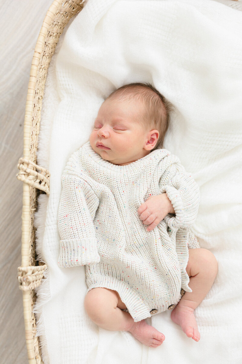 Portrait of a newborn baby boy laying in a basket by northern kentucky newborn photographer missy marshall