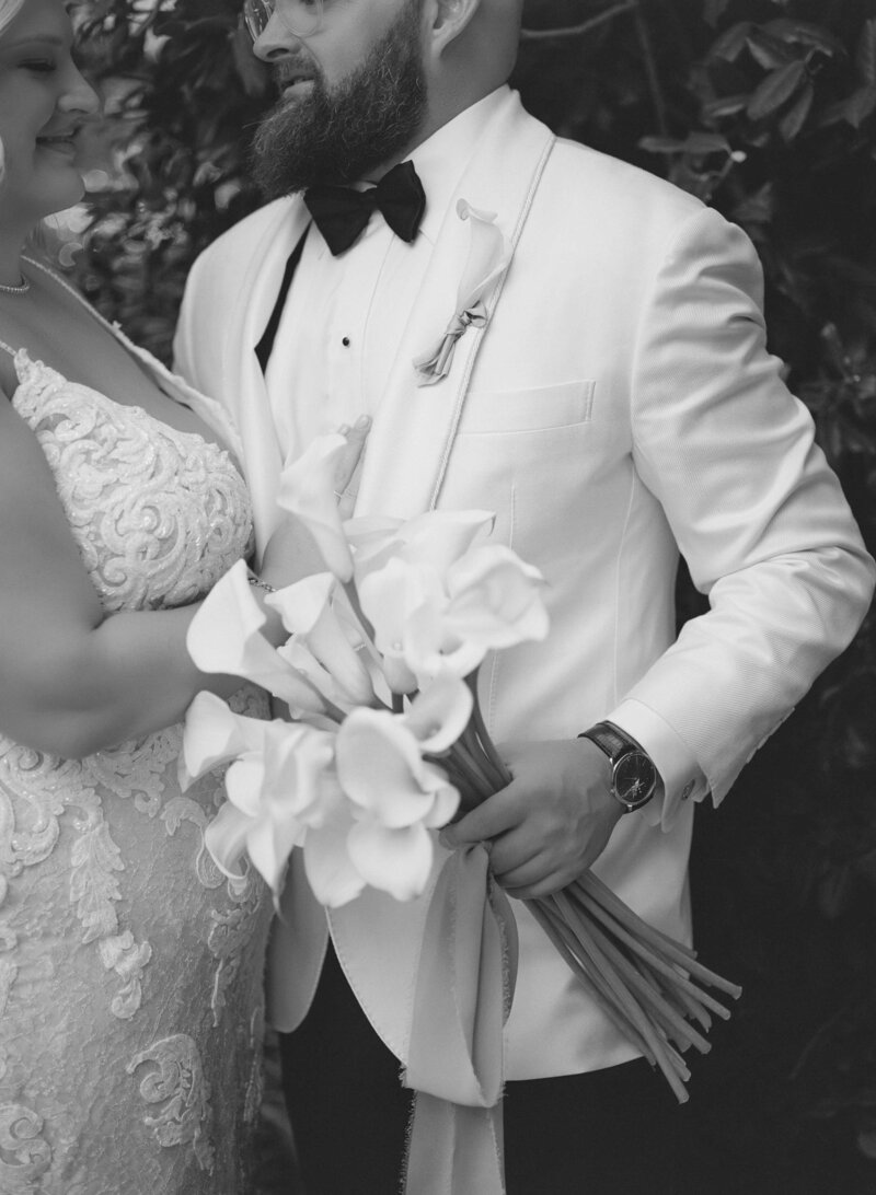 A black and white image close up on bride and groom