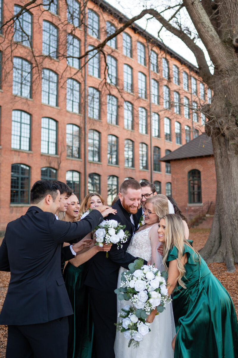 Wedding party group hug outdoors