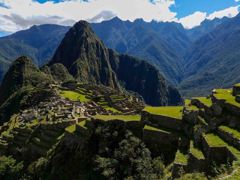 Ancient Incan ruins of Machu Picchu, surrounded by green terraces and towering Andean peaks in Peru ©Stephanie Dosch | theViatrix Luxury Travel