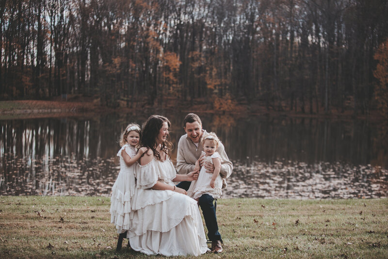 Family Portrait of young family with toddlers laughing and having fun