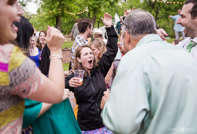 Party on the flagstone patio at Riverbend wedding reception in Lyons Colorado