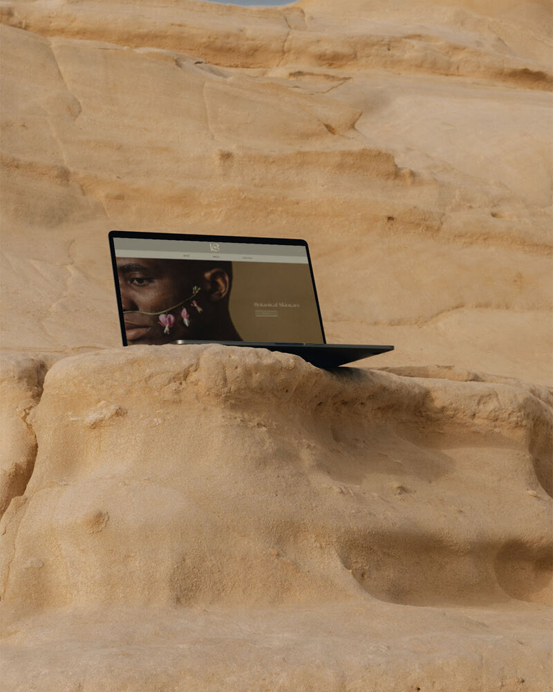 Laptop sitting on a sandy cliff