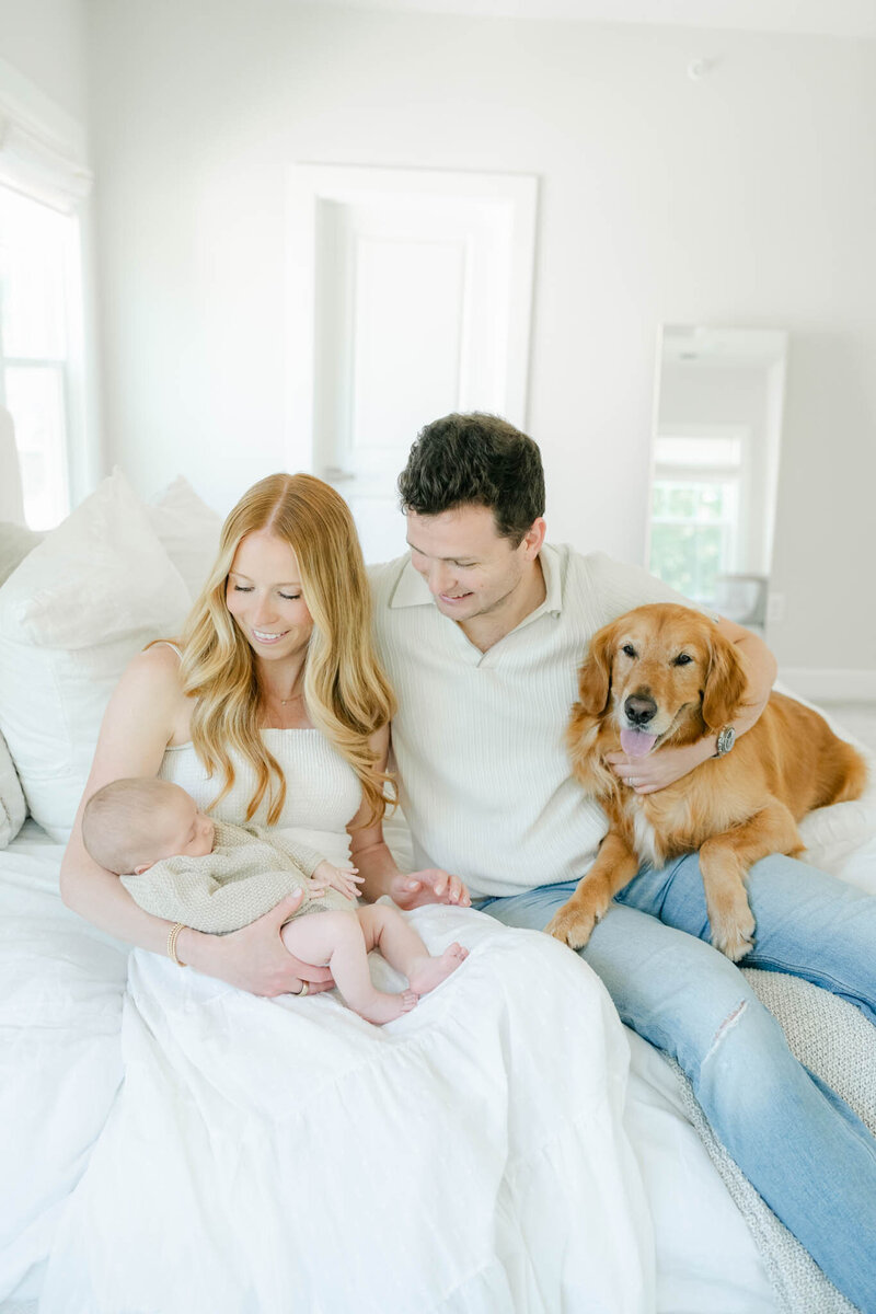 family poses with newborn baby and toddler