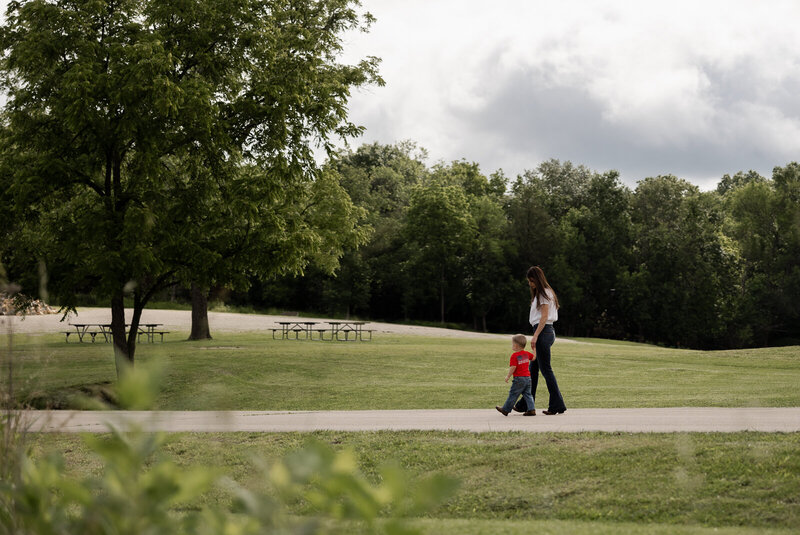 Mom walking with child on the street in the distance. 
