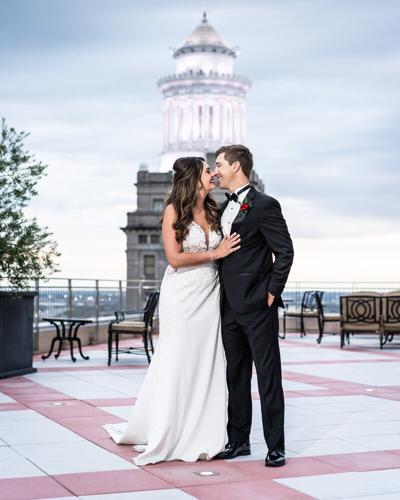 Rooftop portrait of bride and groom at Capital on Baronne wedding, with Hibernia Building in the background