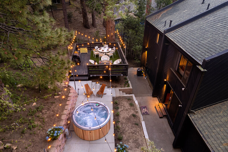 backyard-with-a-spa-and-string-lights-at-twilight-