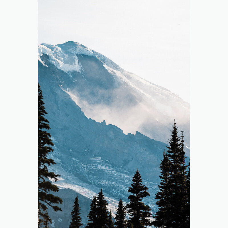 a cloud settling in between the ridges of Mt Rainier
