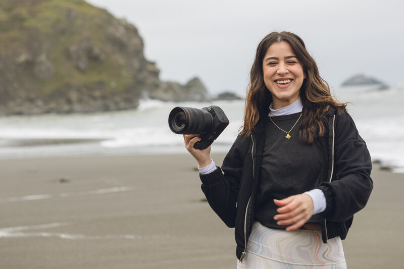 Karen Michelle smiling and holding a camera, Philadelphia wedding photographer
