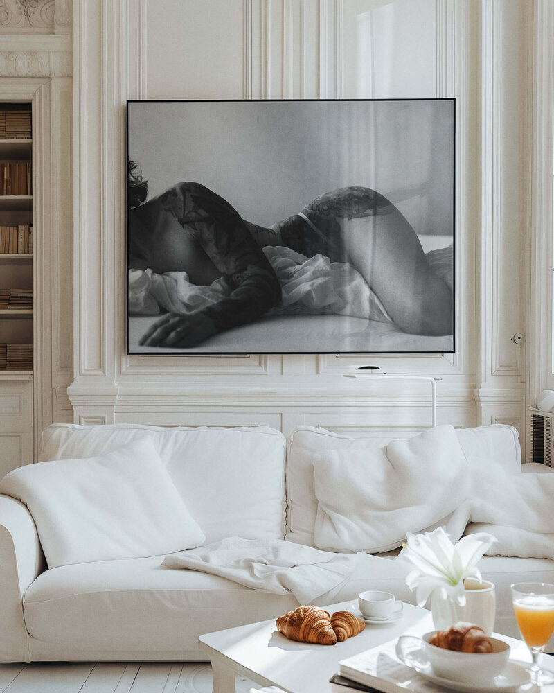 Black and white boudoir portrait displayed in a luxury living space, photographed by The Picture House in Birmingham, Alabama.