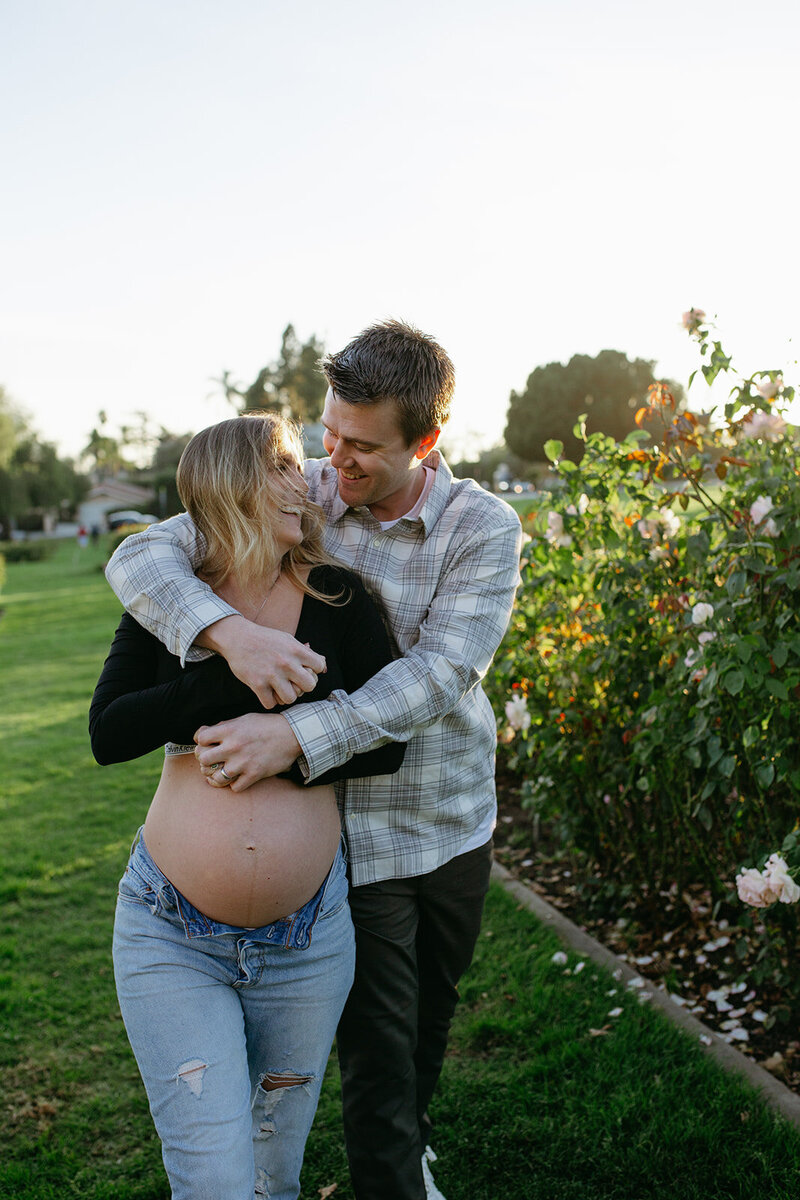Couple embrace as they enjoy their maternity photo session in Santa Barbara
