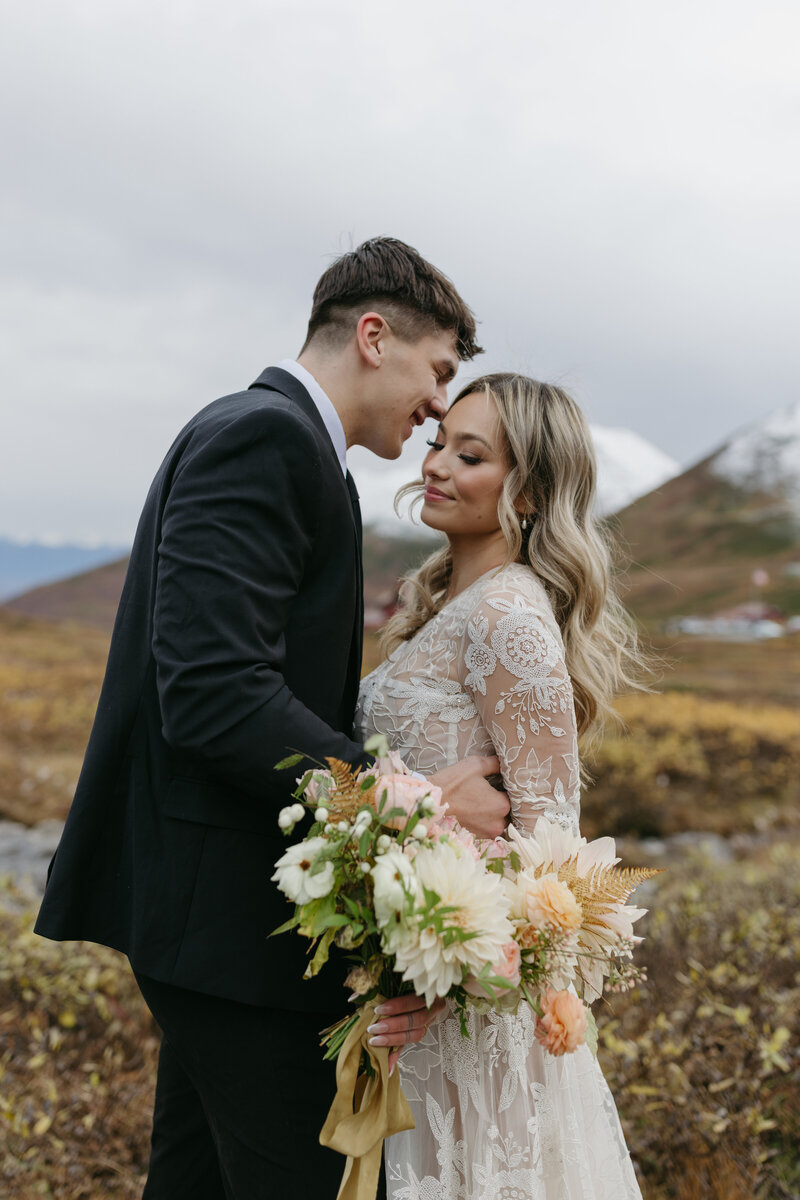 A couple standing together on a fall day in Hatcher Pass.