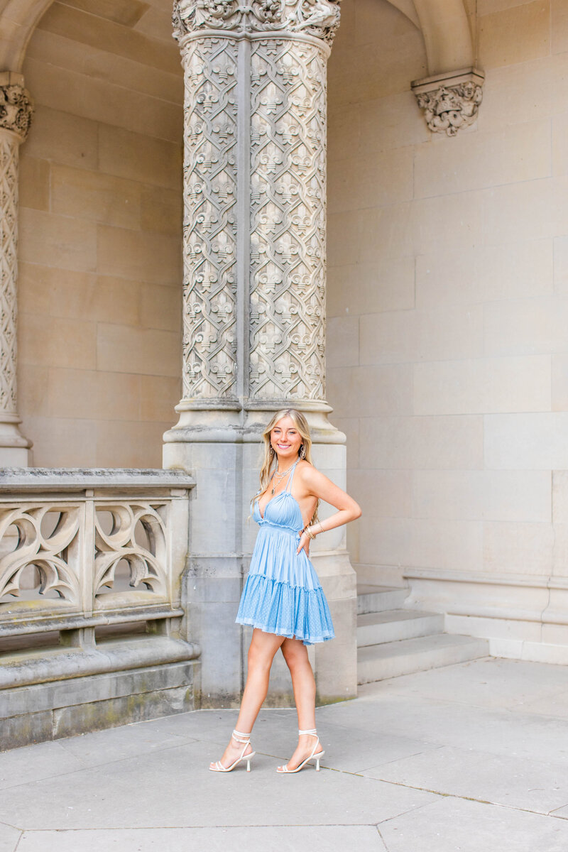 high school girl in blue dress in front of column at Biltmore Estate