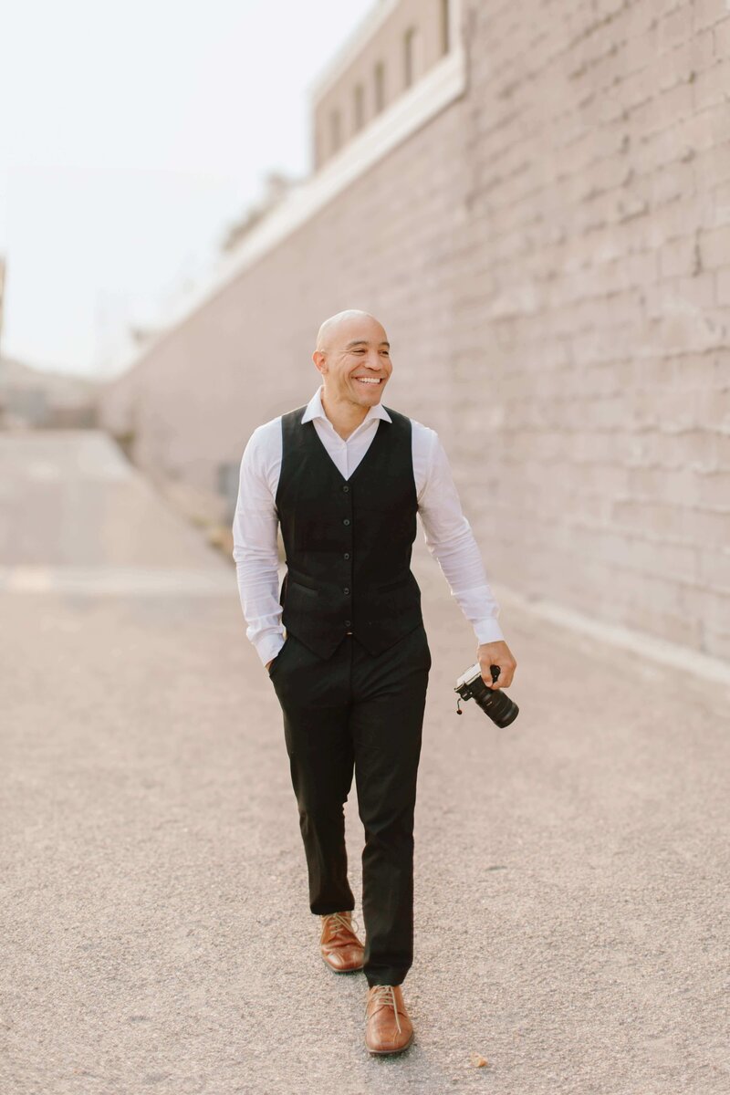 St. Paul Wedding Videographer Ariel walking with Camera