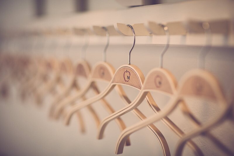 Wooden clothes hangers neatly hanging in closet