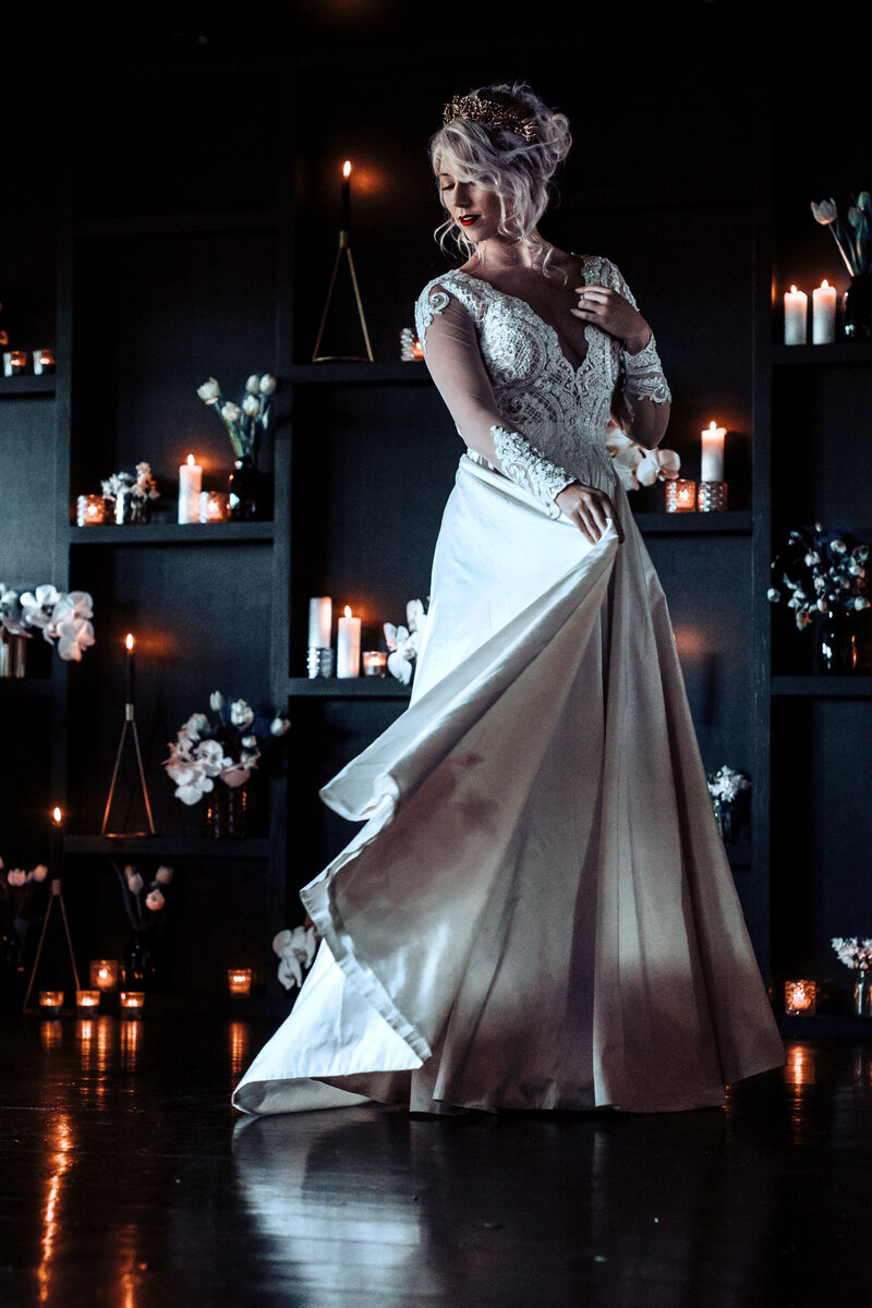 Romantic lace wedding dress in a candlelit reception room