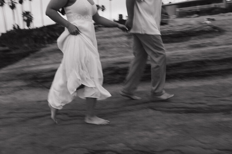 girlfriend and boyfriend running on beach for documentary style photoshoot