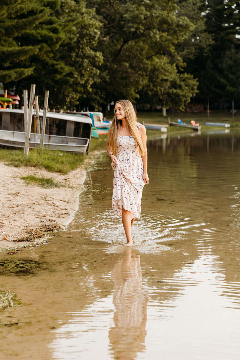 high school senior walking on a beach  for senior photography session in Green Bay