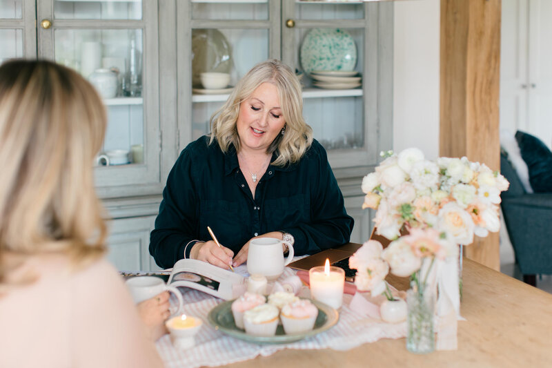 Anna Sawle | Wedding flowers in Cornwall decorating a reception table with flowers for a Carbis Bay Hotel wedding