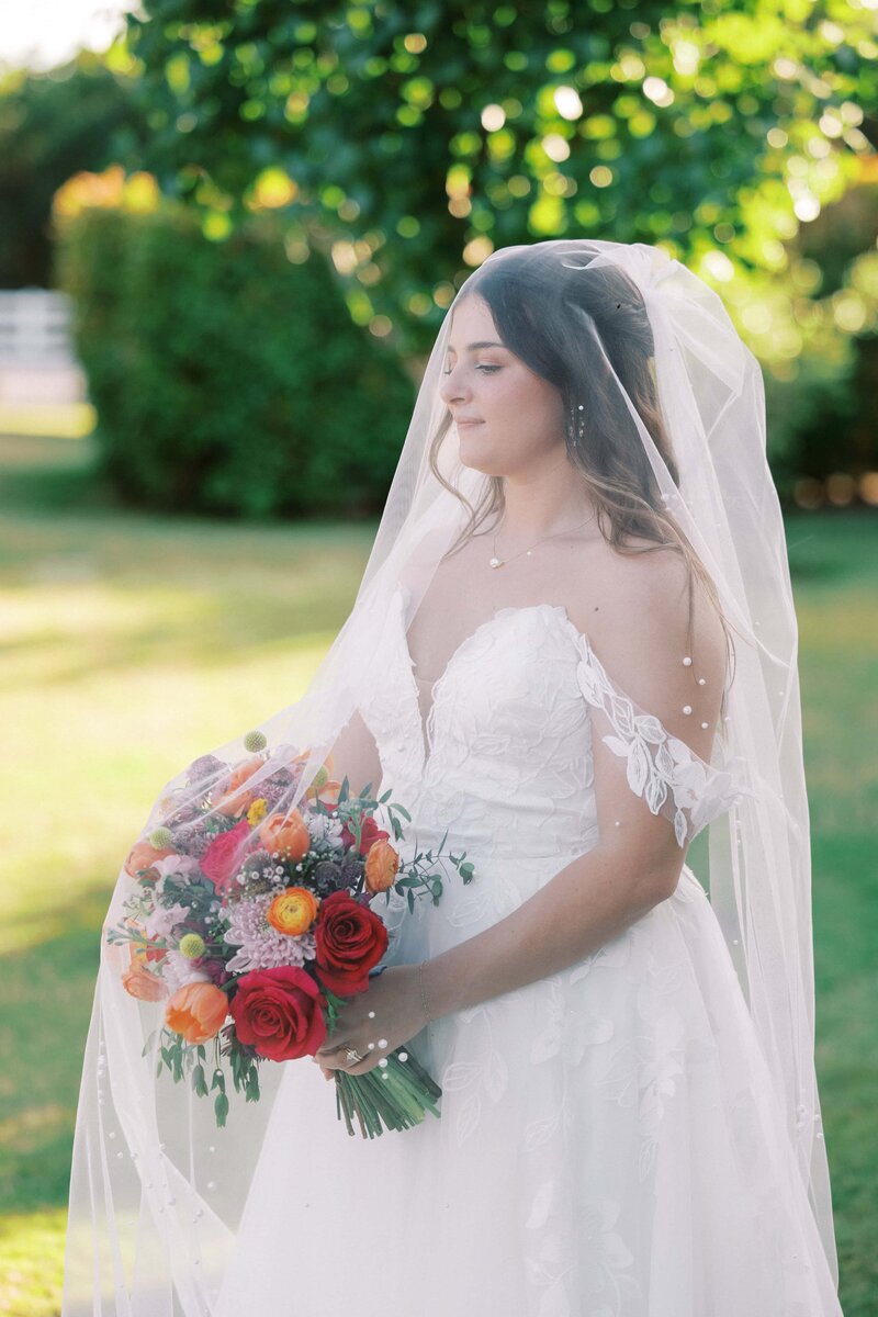 bride under her veil holding her bouquet