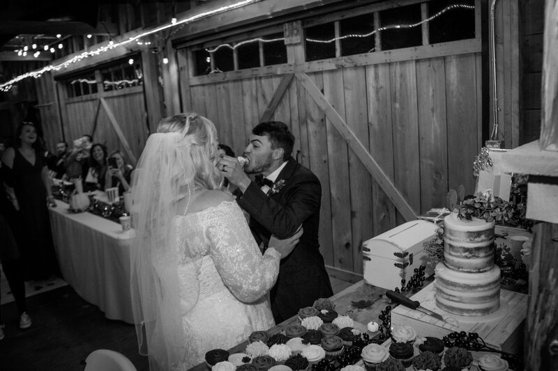 Bride and Groom giving each other cake | Rangeley, Maine Wedding Photography