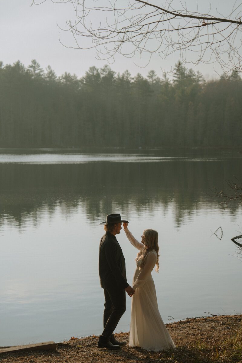 couple holding hands on Lake Minocqua