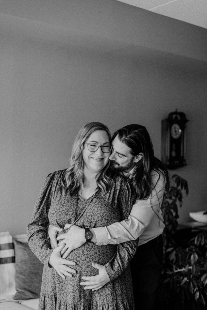 At Home maternity session in Winnipeg, couple in living room