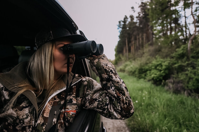 girl with binoculars in car