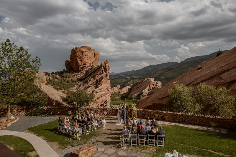 Luxurious outdoor wedding ceremony site with the guests sitting down and on going wedding ceremony