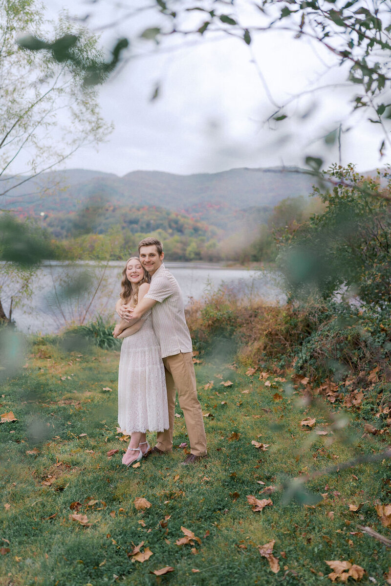 couple hugs at cove lake state park near knoxville tennessee with mountain view