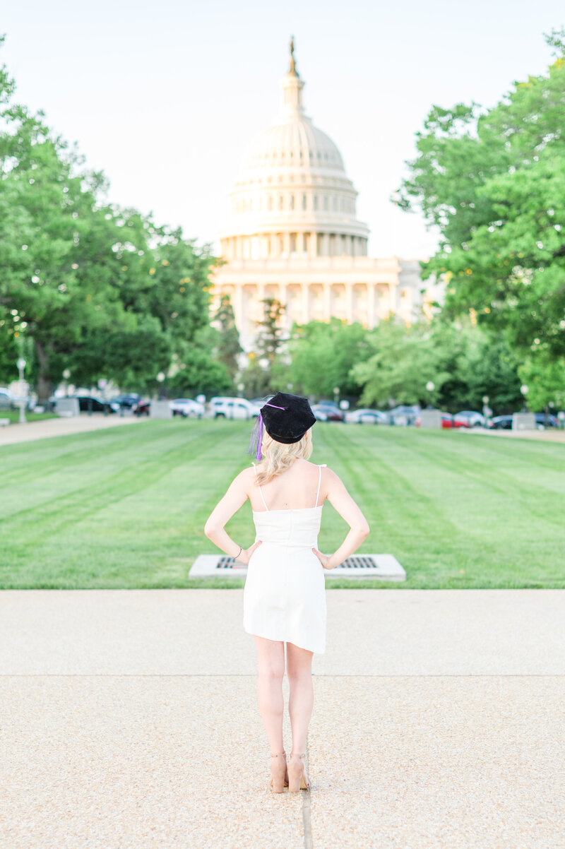 Stands in front of the US Capitol during Baltimore Maryland Grad session