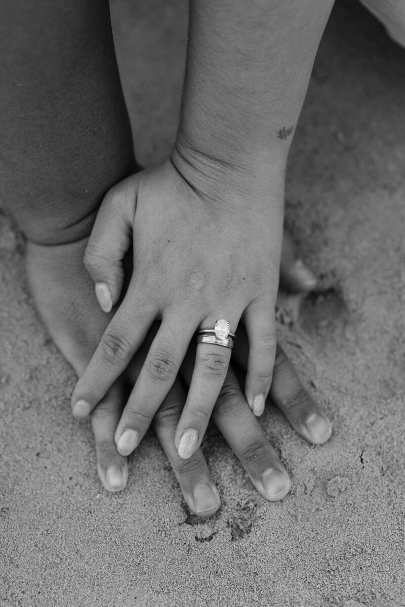 Oahu Hawaii elopement bride and groom at Secret Island Beach with wedding rings in sand.
