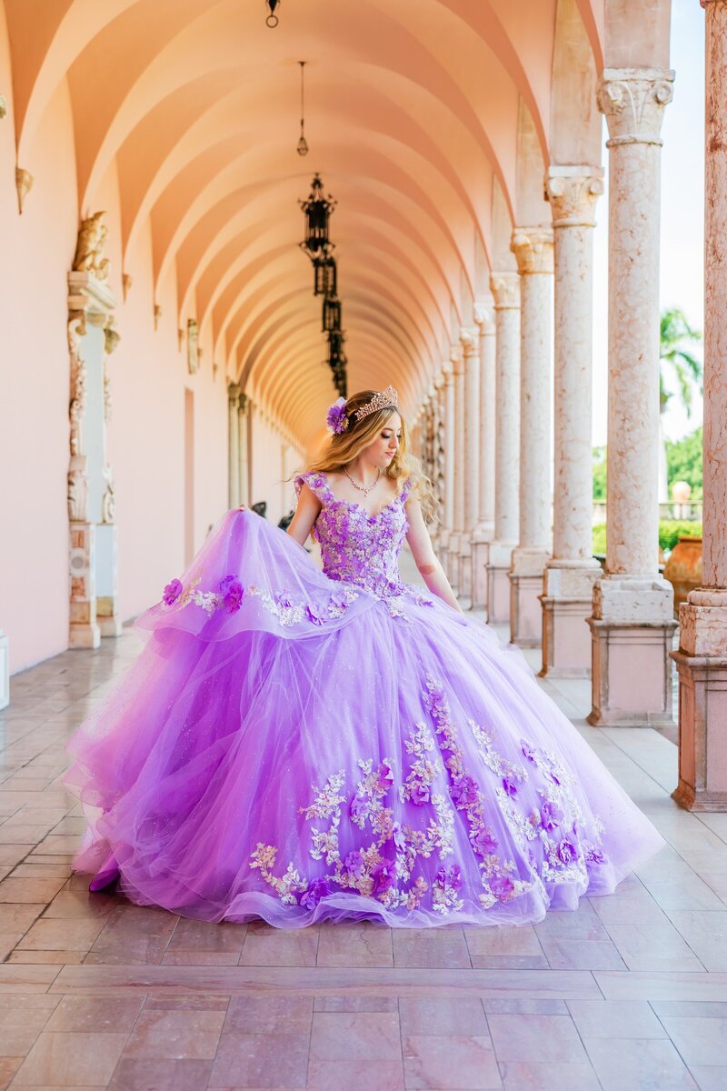a young girl posing for her quinceanera photoshoot in the courtyard of The Ringling Museum in Sarasota