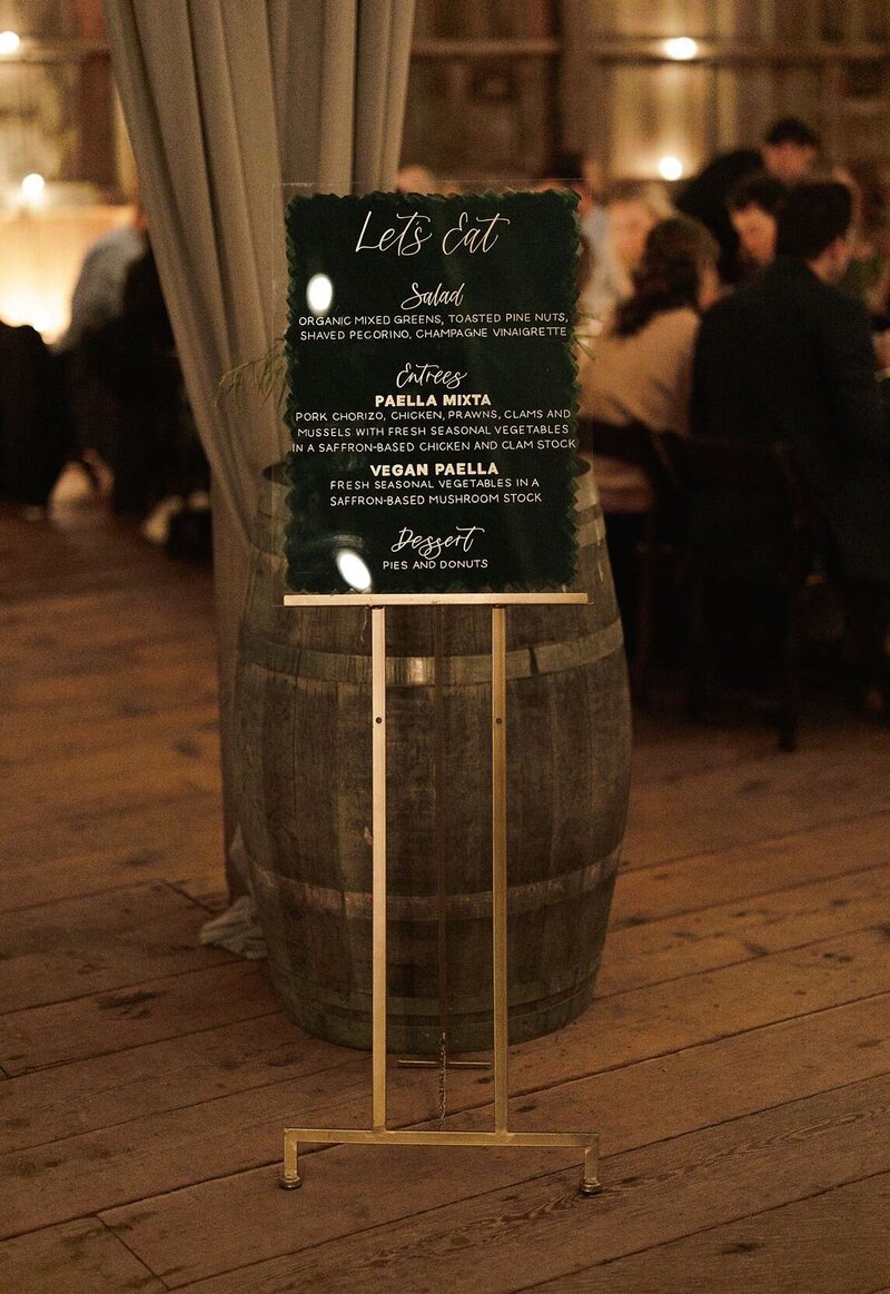Buffet menu sign on a gold easel for a wedding