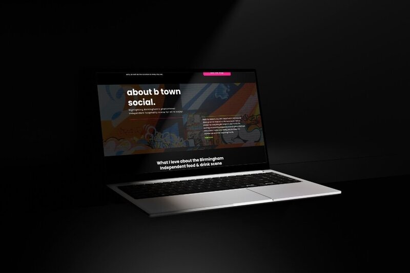 Laptop displaying a website with a dark theme, colorful street art header, and bold white text reading “about b town social,” focused on Birmingham’s independent food and drink scene.