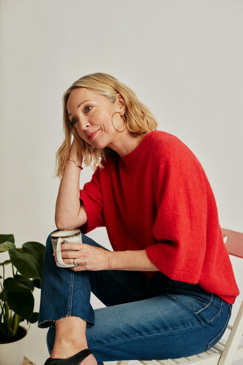Mature woman smiling with a cup in hand
