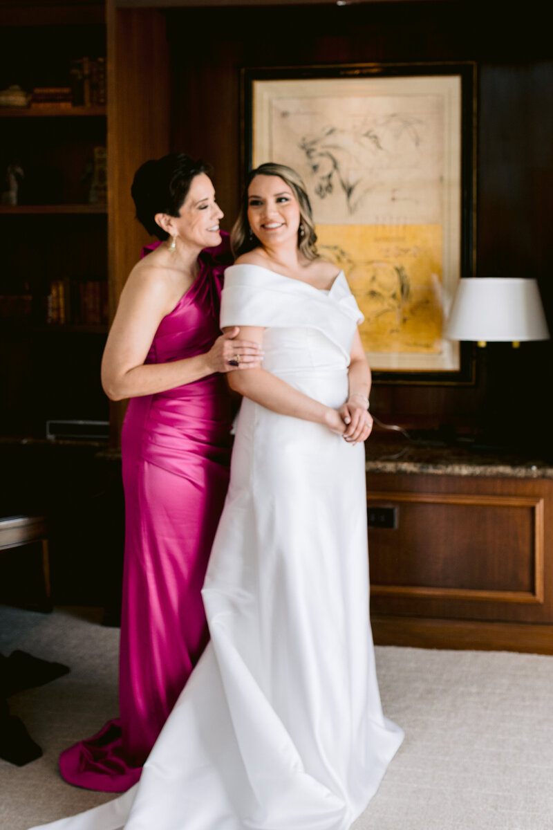 mother of bride embraces bride