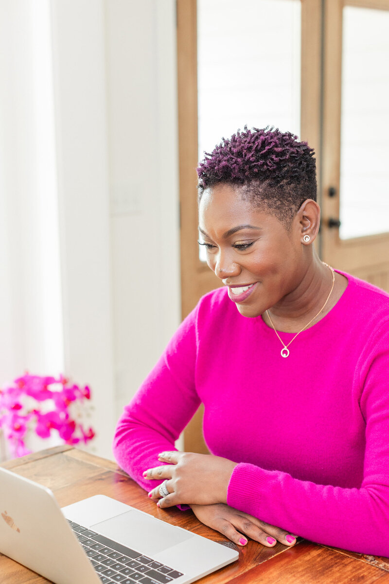 Woman wearing a black hat happily looking at the view
