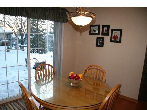 dimly lit kitchen with a wooden kitchen table