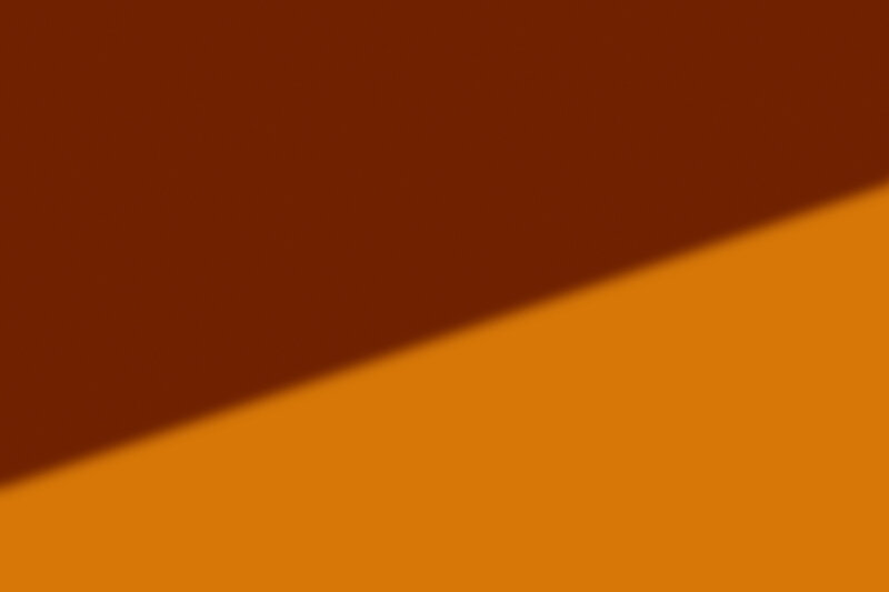 A linear shadow on an orange backdrop