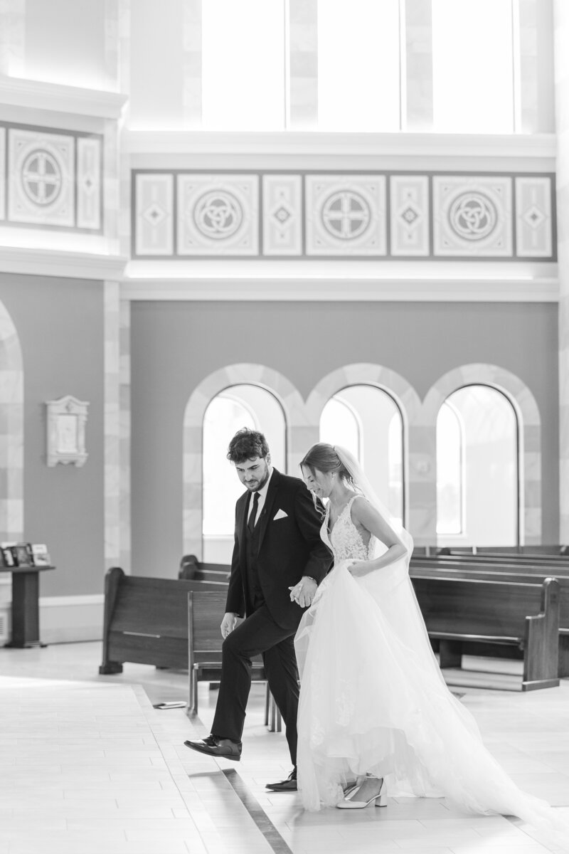 bride and groom walking in a Catholic church on their wedding day