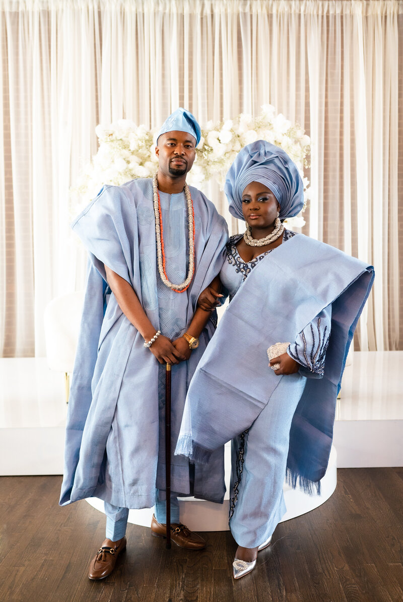 A Nigerian couple standing together in traditional attire