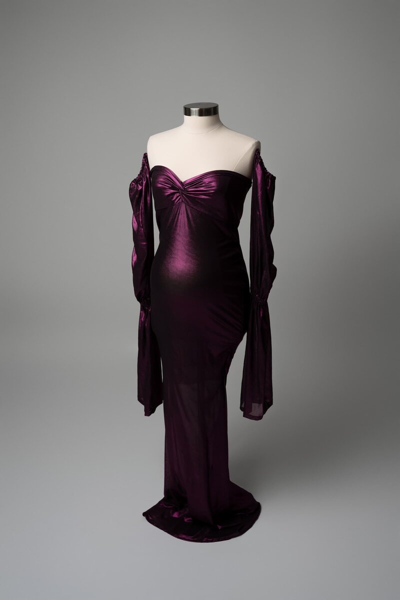 Structured purple dress with long sleeves and sweetheart neckline styled on mannequin for studio shoot