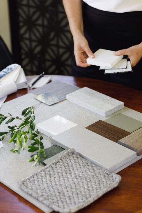 interior designer handling samples of tile, fabric, and wood