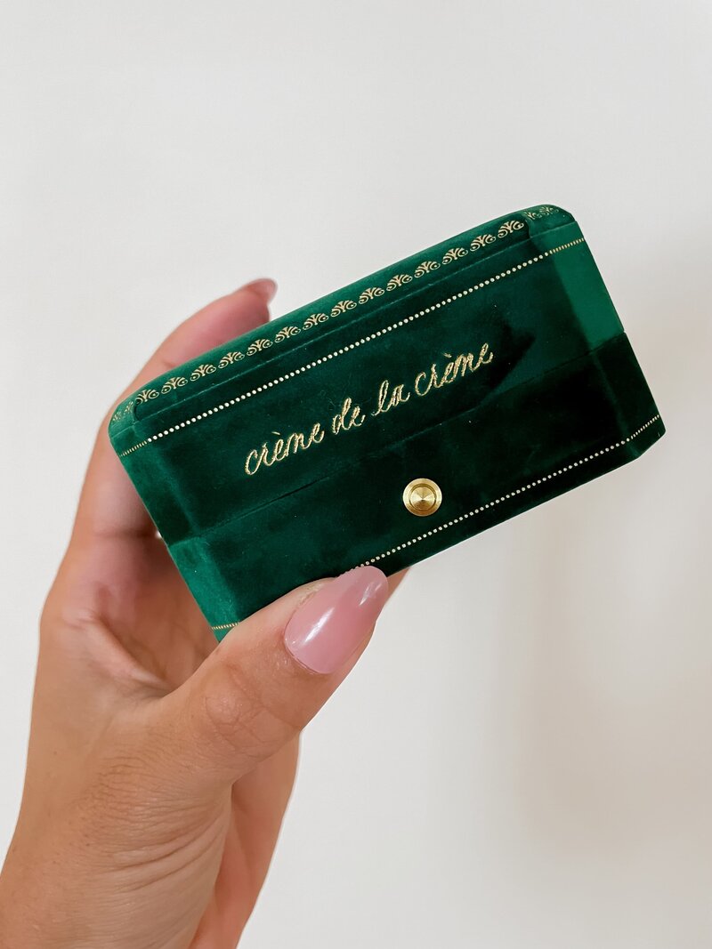Custom calligraphy services on a green velvet jewelry box