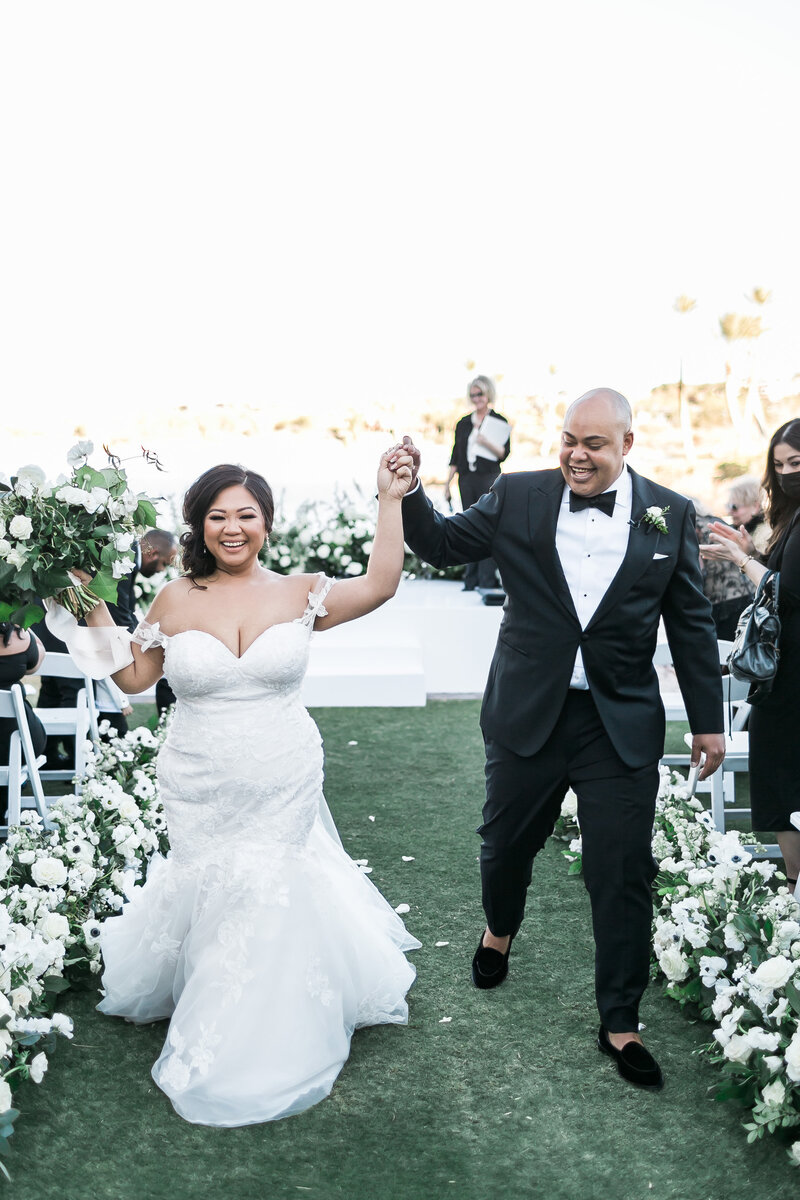 Joy-filled bride and groom walk back down the aisle after getting married at Reflection Bay in Las Vegas