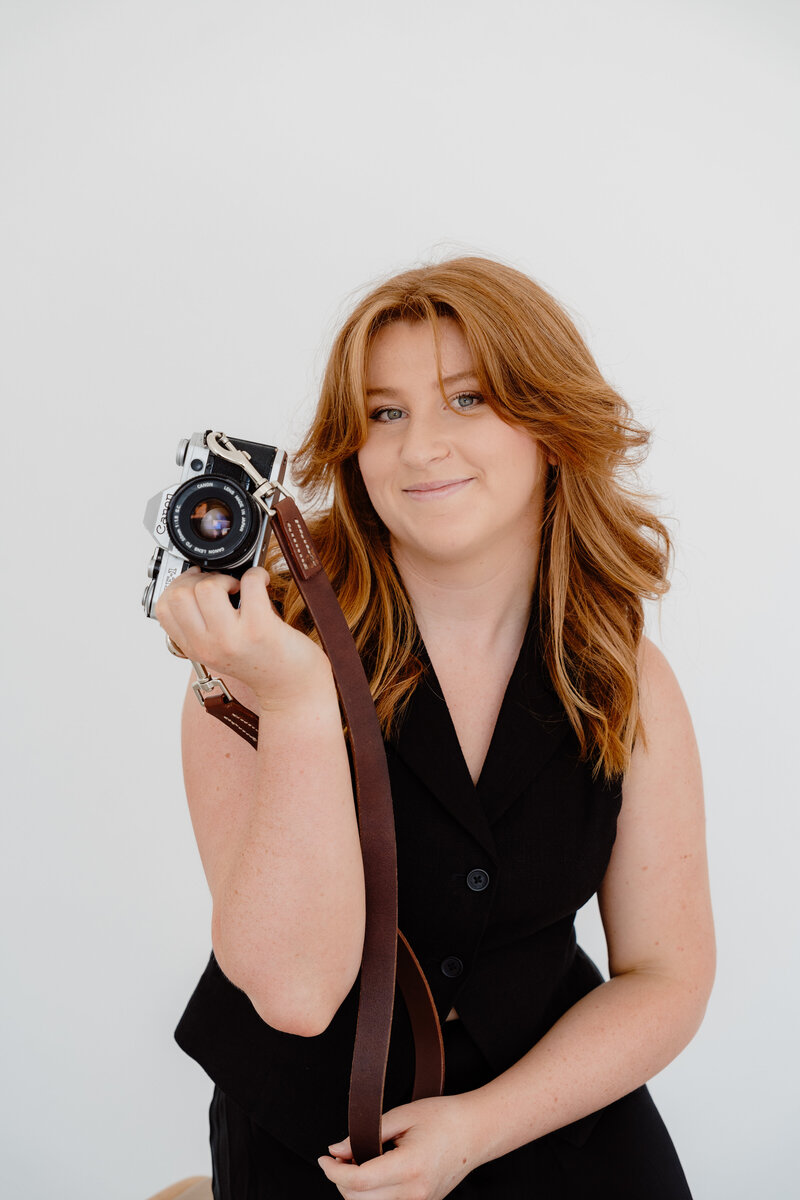 shannan griffiths holding camera on beach