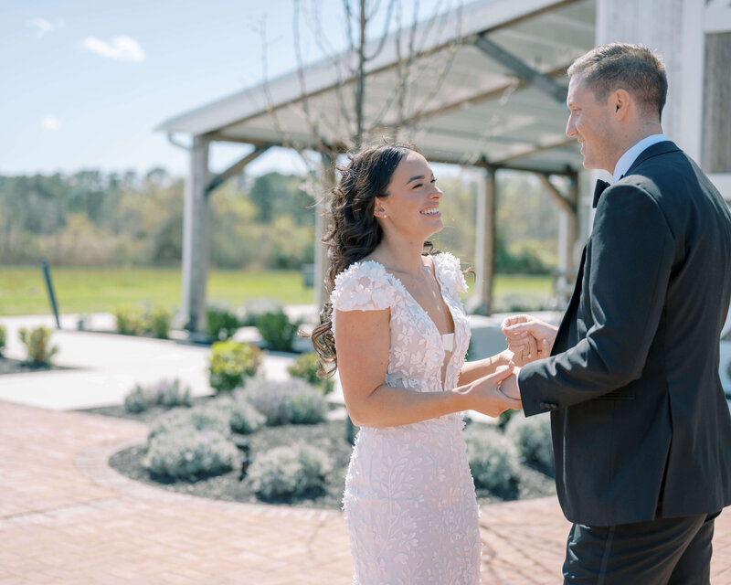 bride and groom holding hands right after their ceremony in a garden